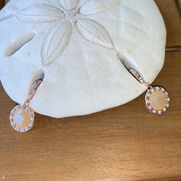 Peach colored earrings surrounded by crystals. - Picture 2 of 5